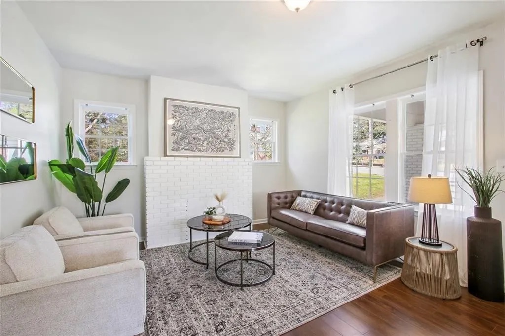 Finished living space with wood flooring and fresh white walls