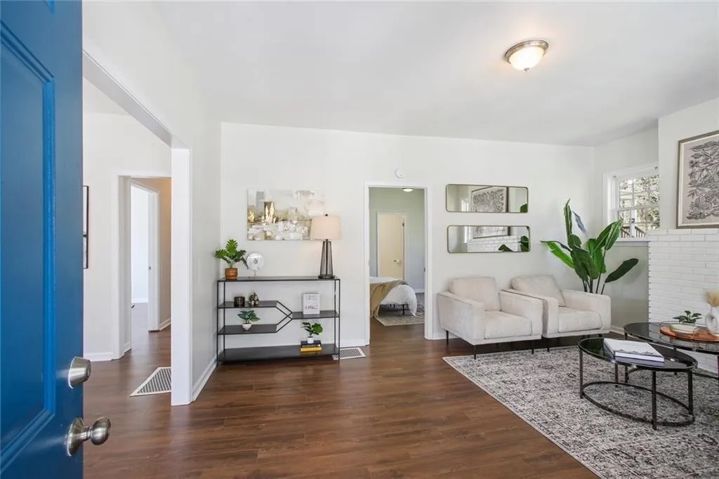 Finished living space with wood flooring and fresh white walls