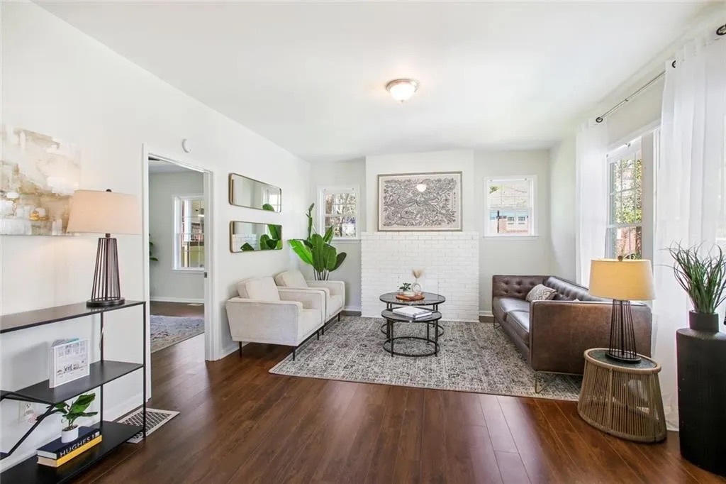 Finished living space with wood flooring and fresh white walls
