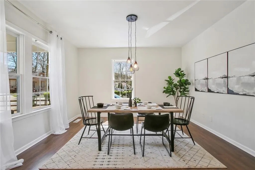 Finished living space with wood flooring and fresh white walls