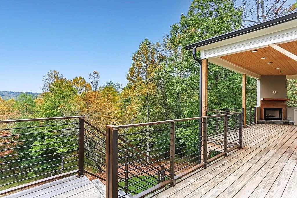 Open great room with hardwood flooring and tall windows