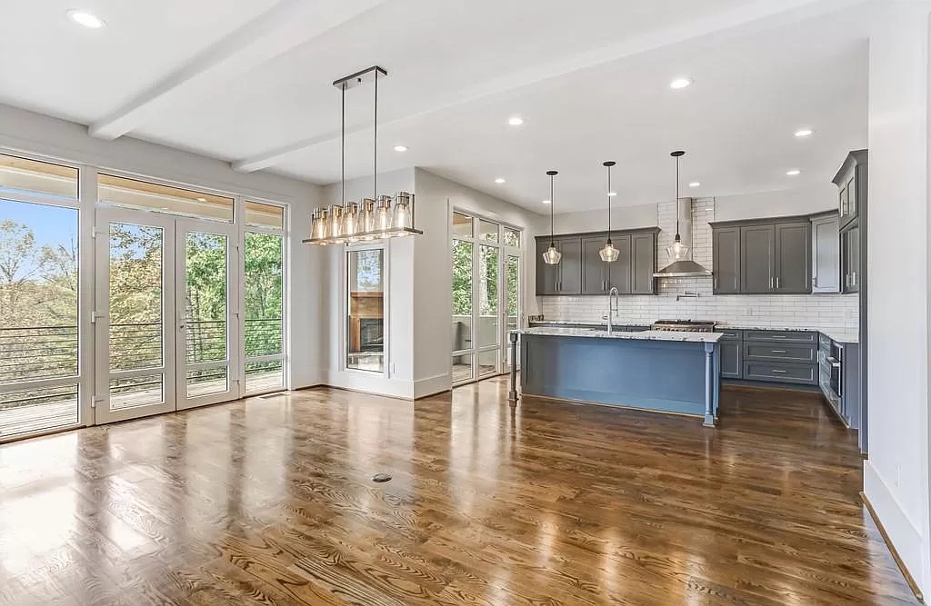 Open great room with hardwood flooring and tall windows in Doraville