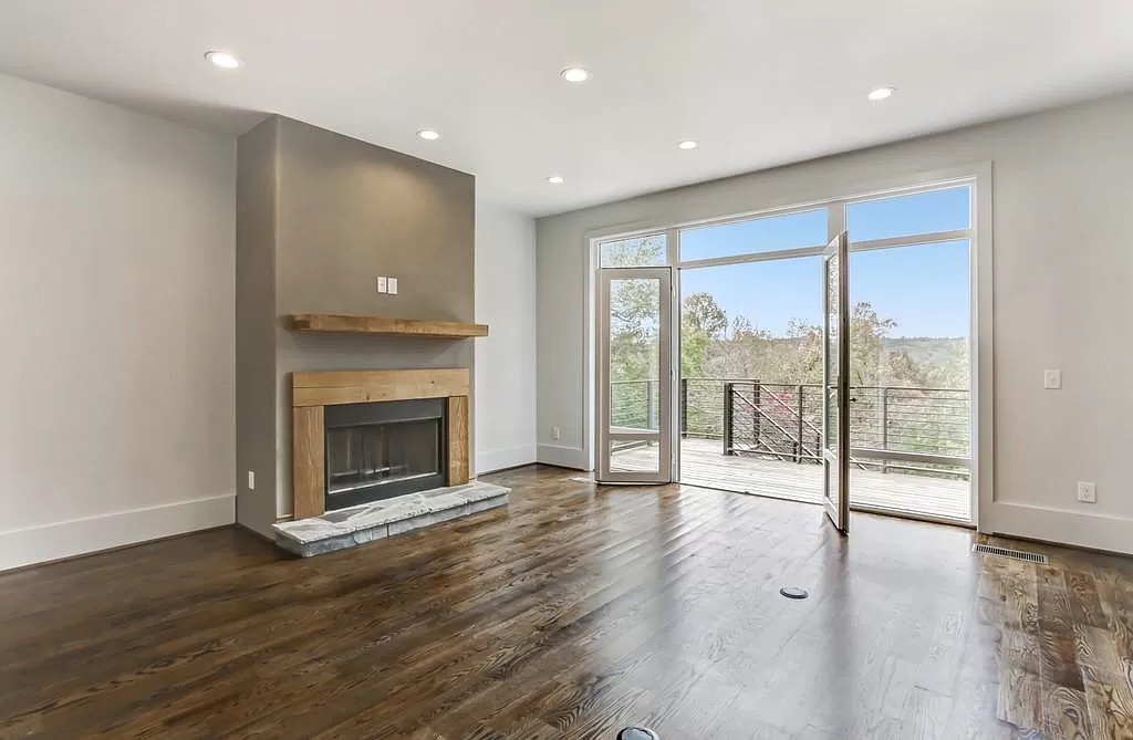 Open great room with hardwood flooring and tall windows in Suwanee