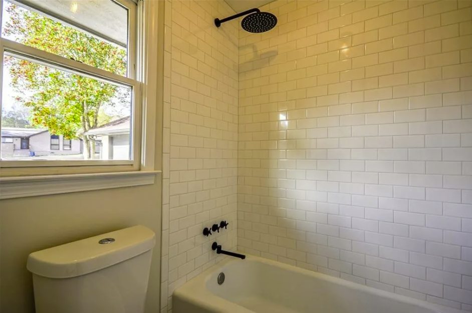 Tiled tub and shower surround with a window