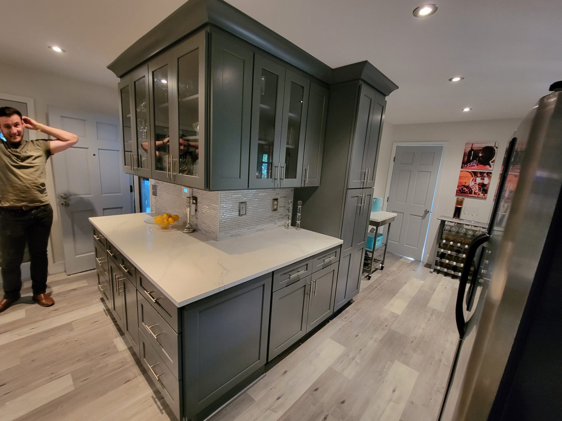 Kitchen with deep green cabinets and a stone island in Austell