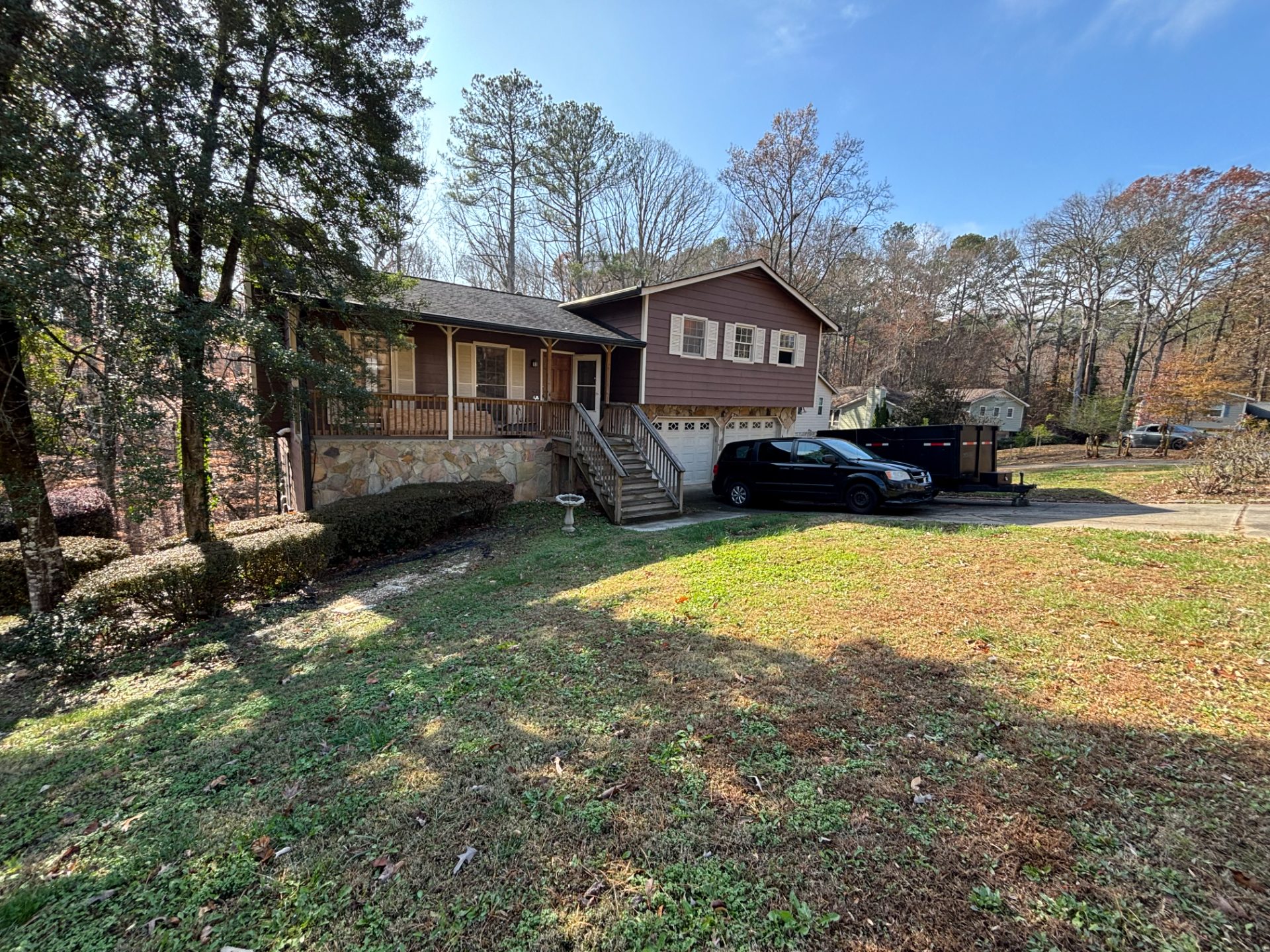 Ranch house with a carport on a wooded lot