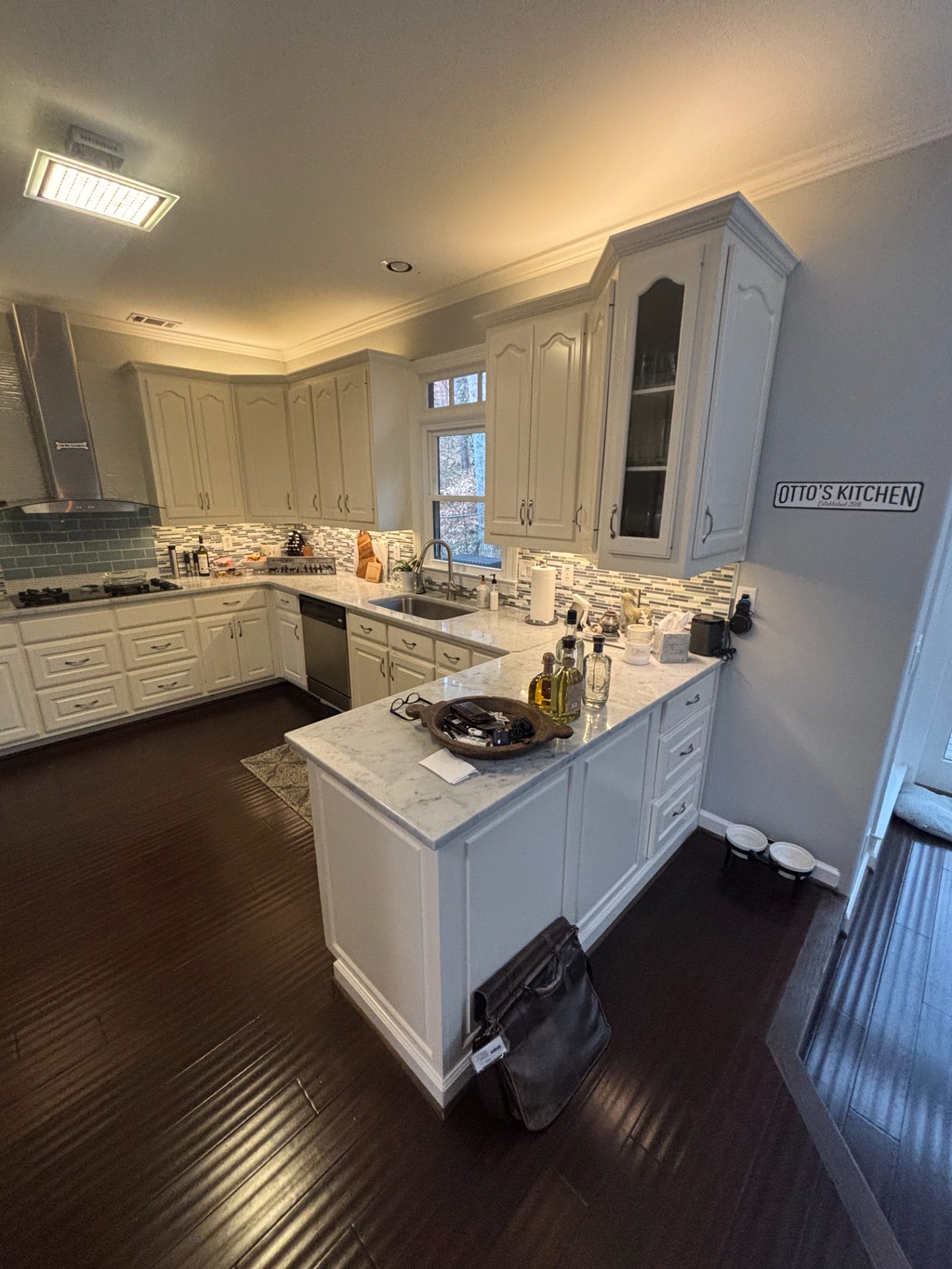Cream-cabinet kitchen with granite counters and a wall oven in East Cobb