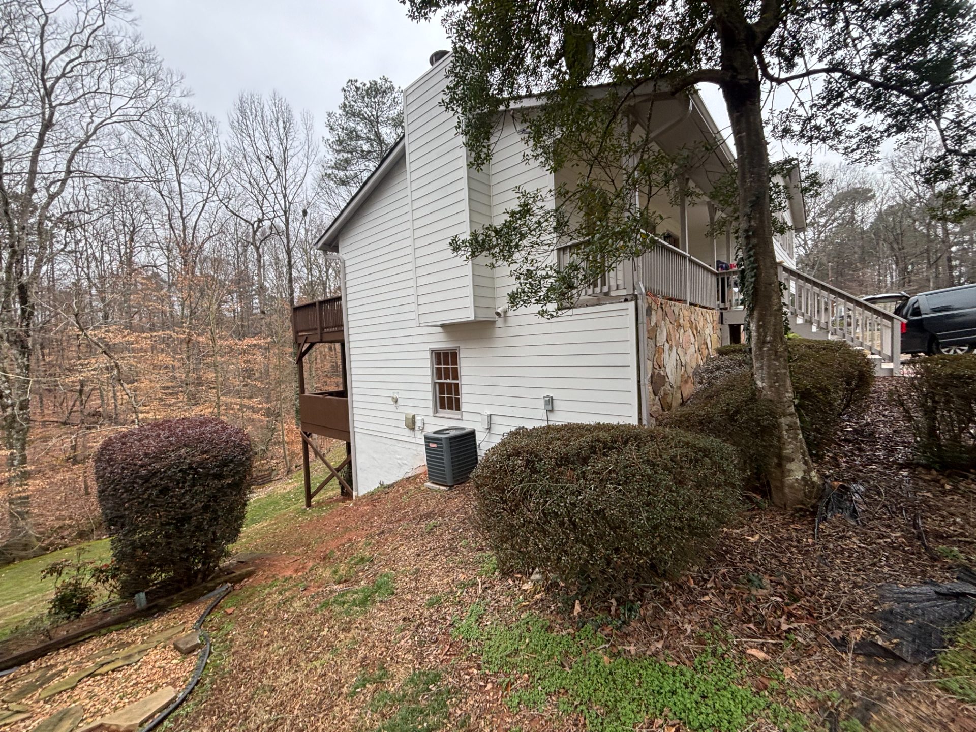 Split-level house on a wooded lot with a rear deck