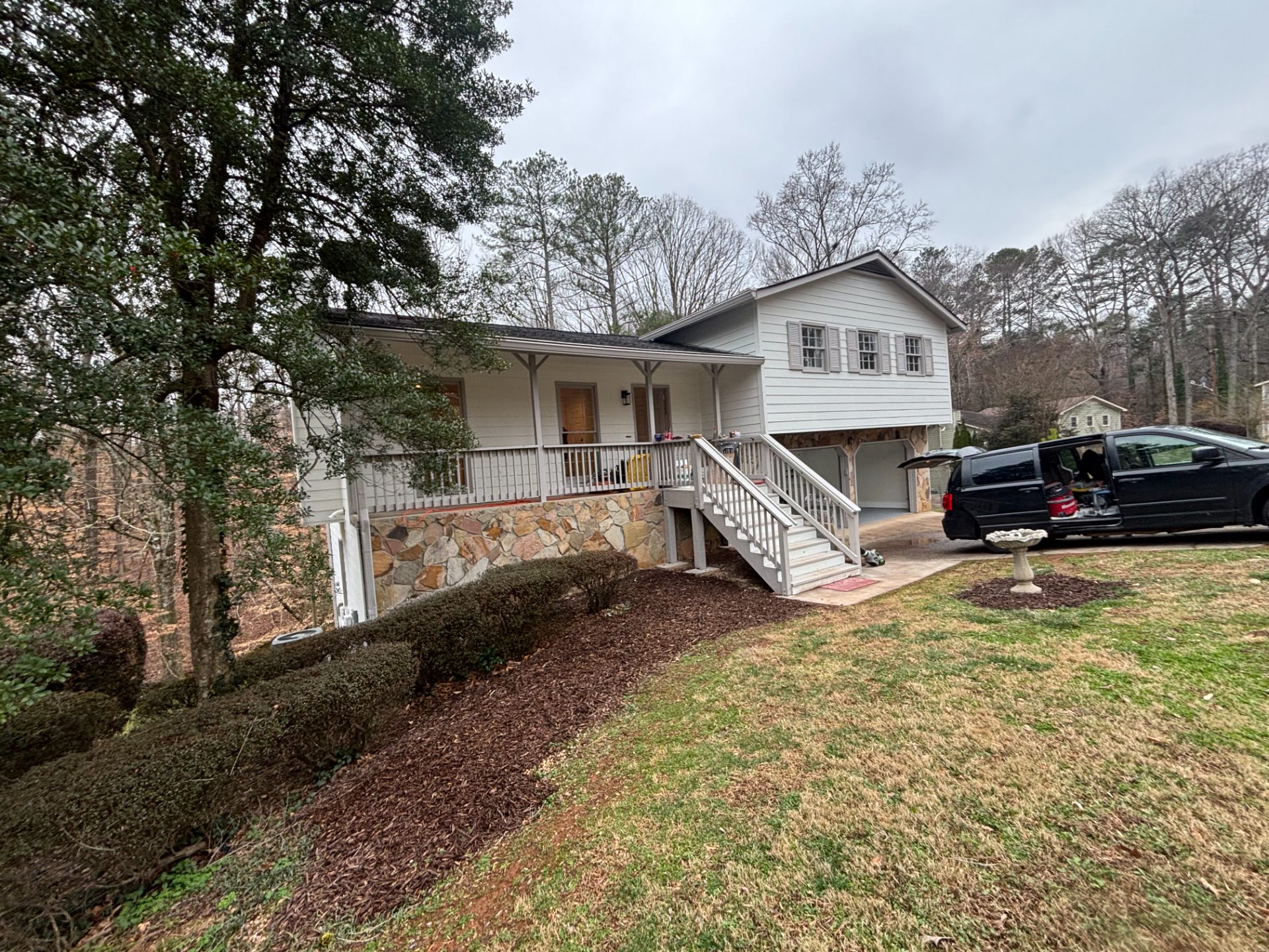 Split-level house on a wooded lot with a rear deck
