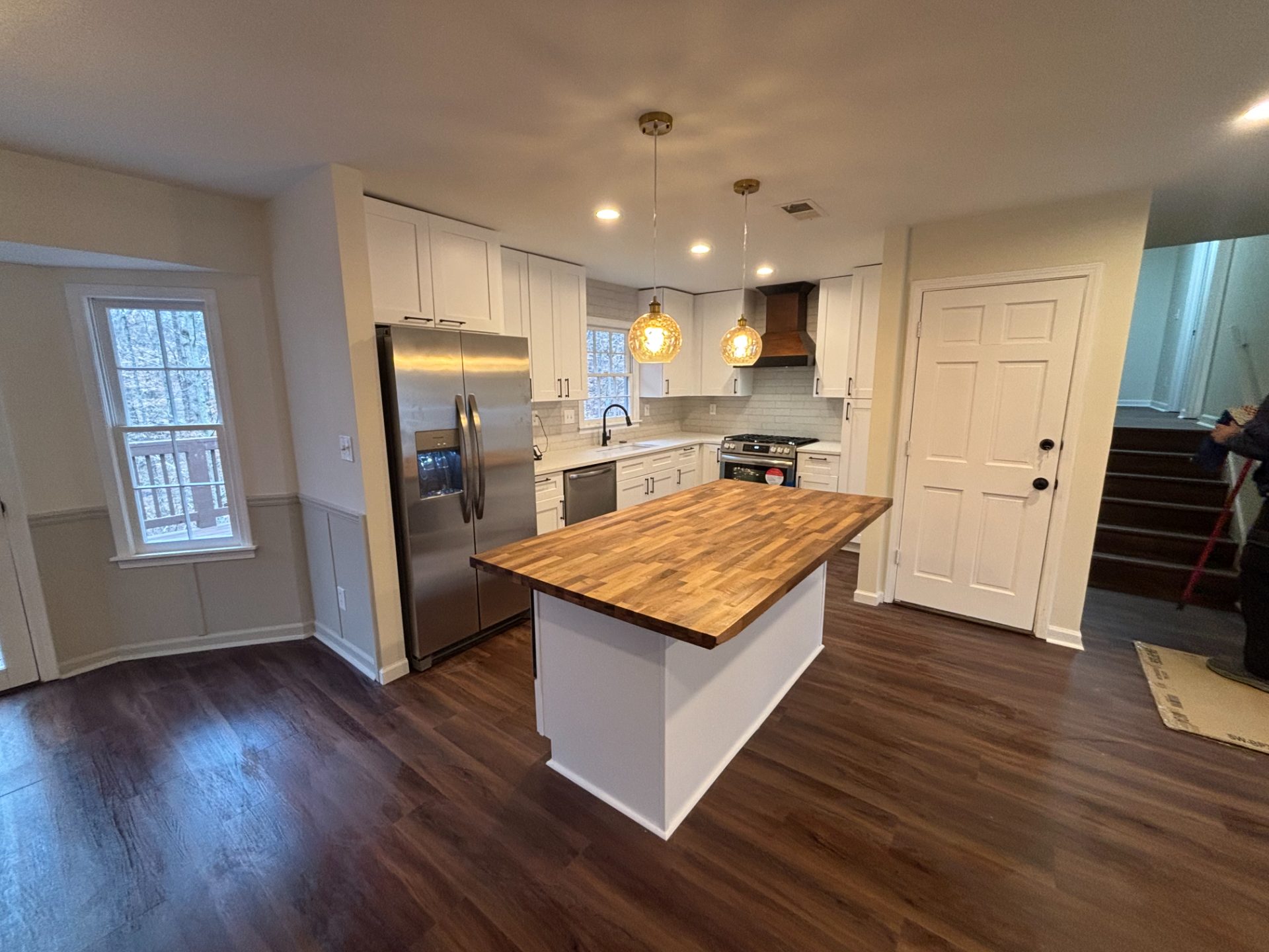 Renovated kitchen with a butcher-block island and white cabinets in North Atlanta