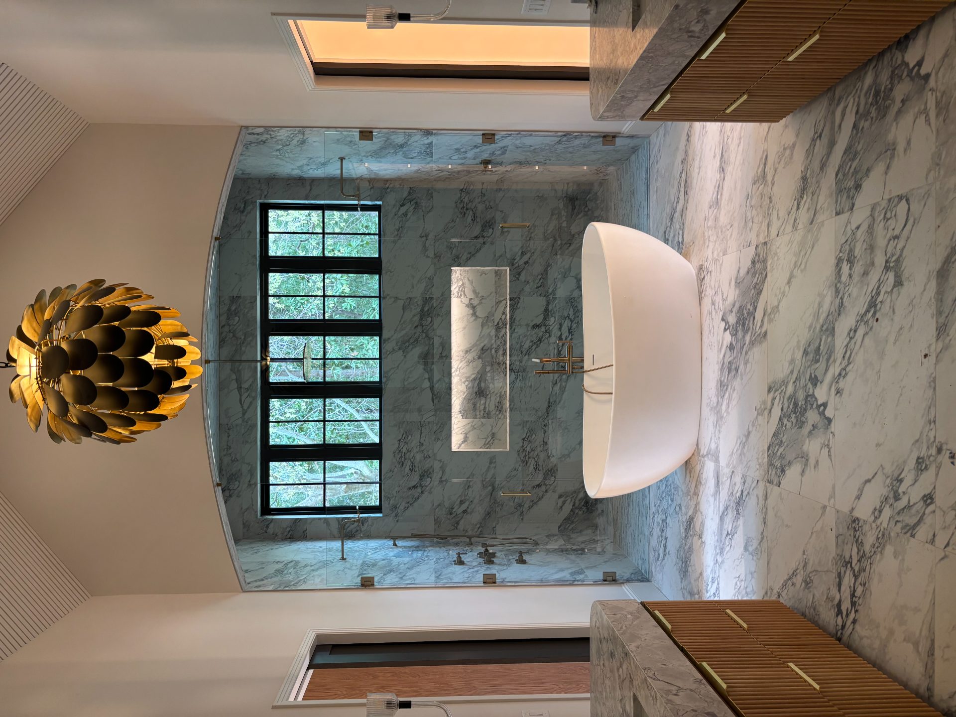 Marble bathroom with a freestanding tub and arched windows in Smyrna