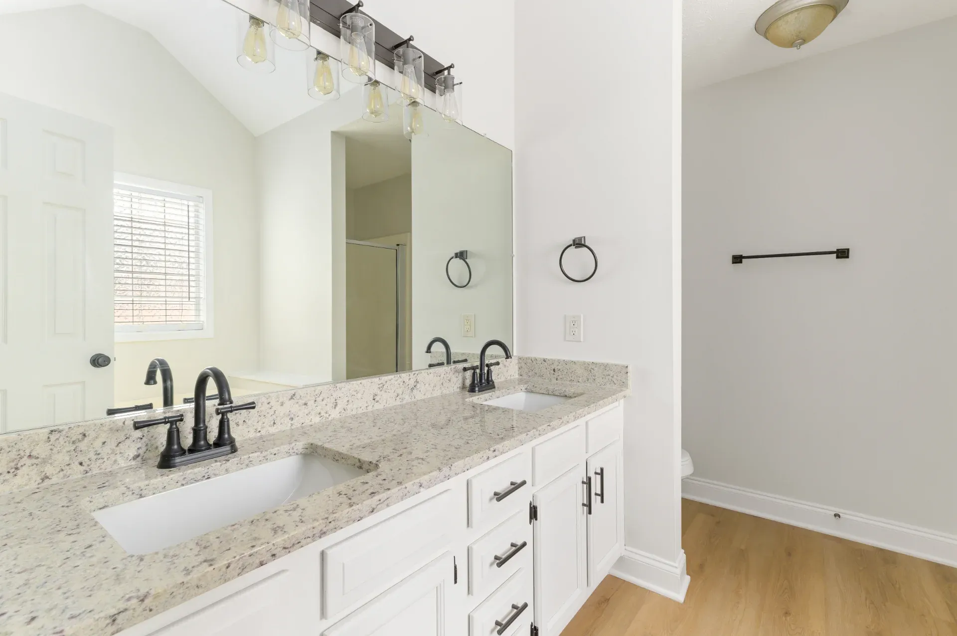 Long kitchen run with granite counters and a double sink in East Cobb