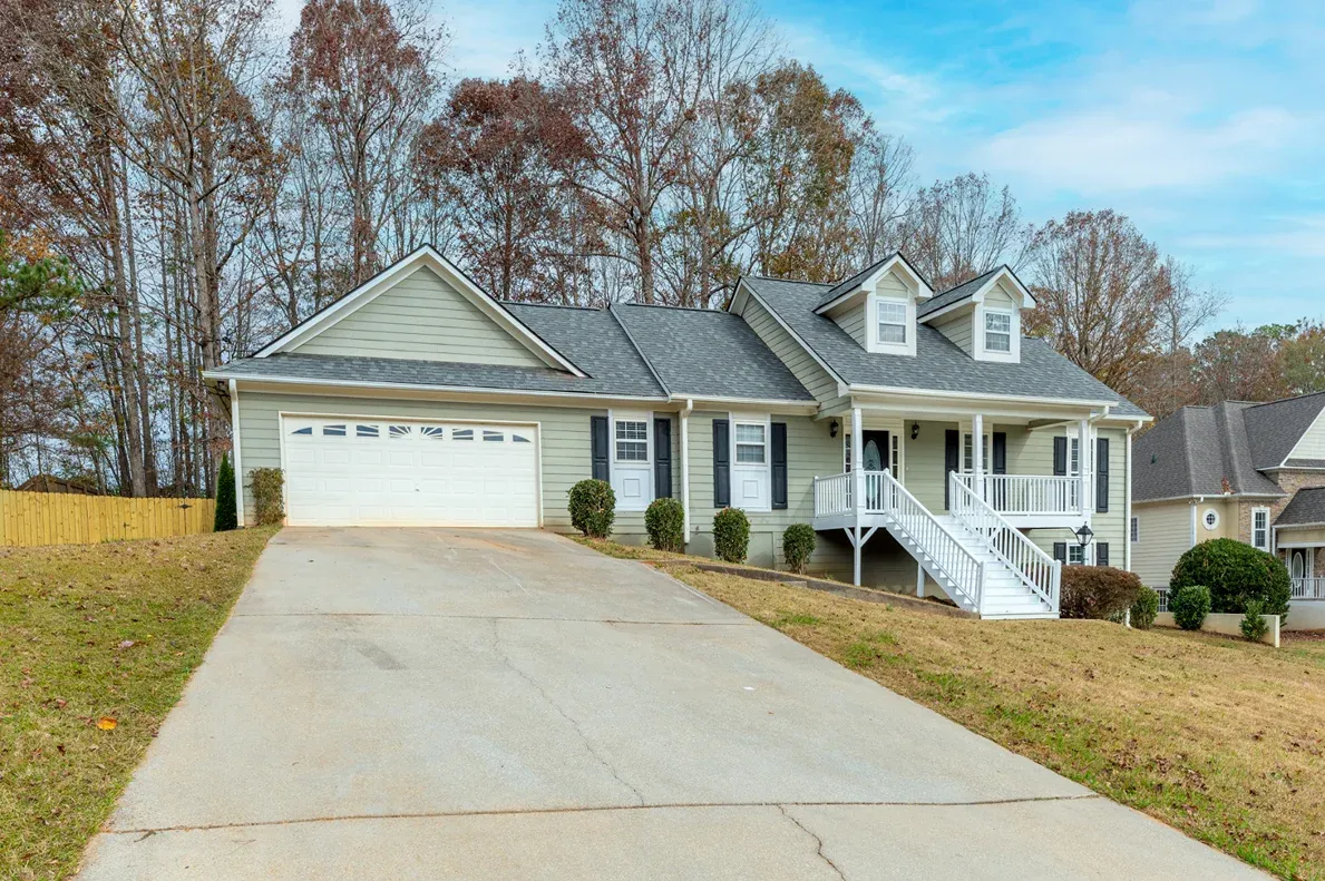 Ranch house with an attached garage and a paved drive in Norcross