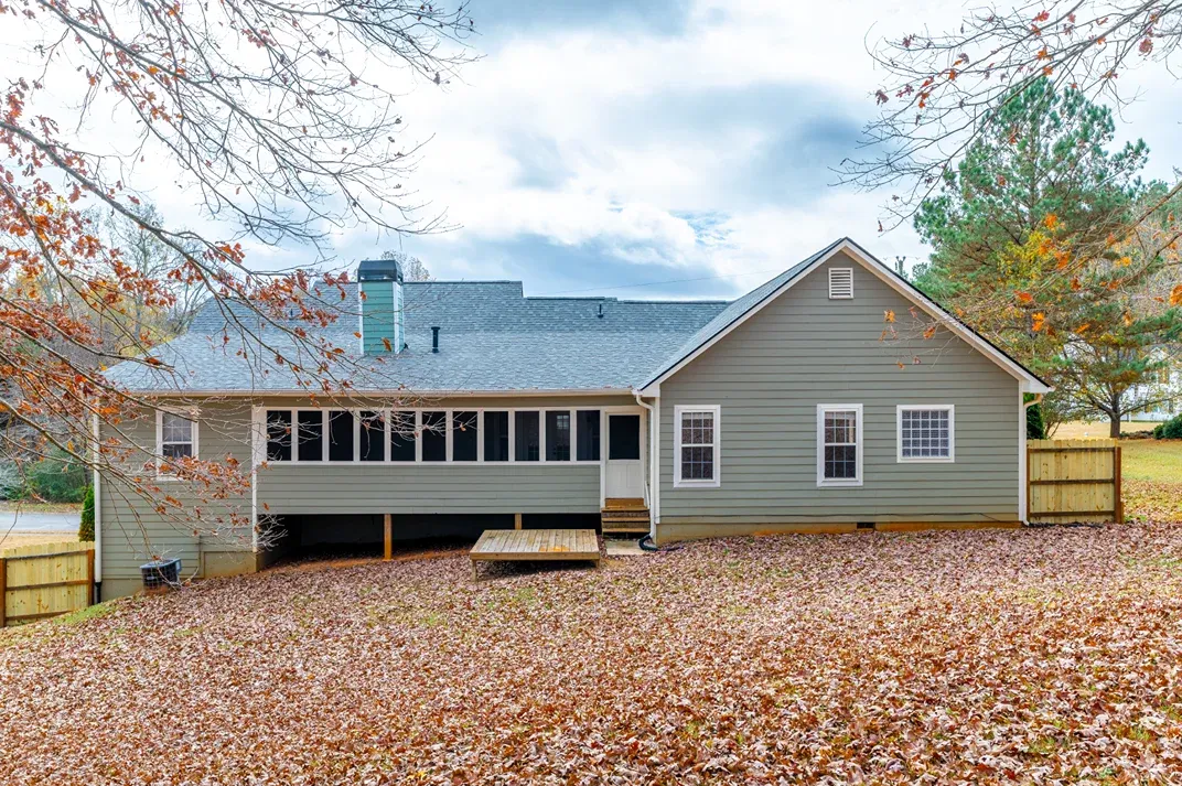 Single-story house with a metal porch roof and white railings