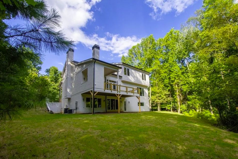 New farmhouse exterior with a standing-seam porch roof in Lilburn