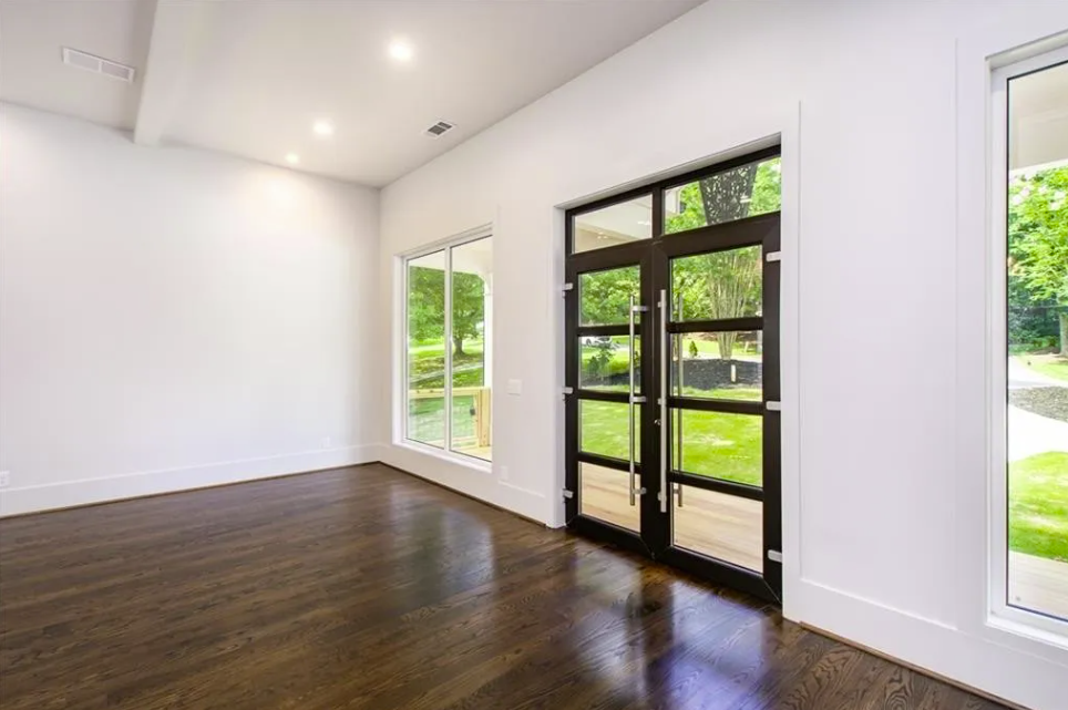Entry hall with glass double doors and hardwood flooring in Stonecrest
