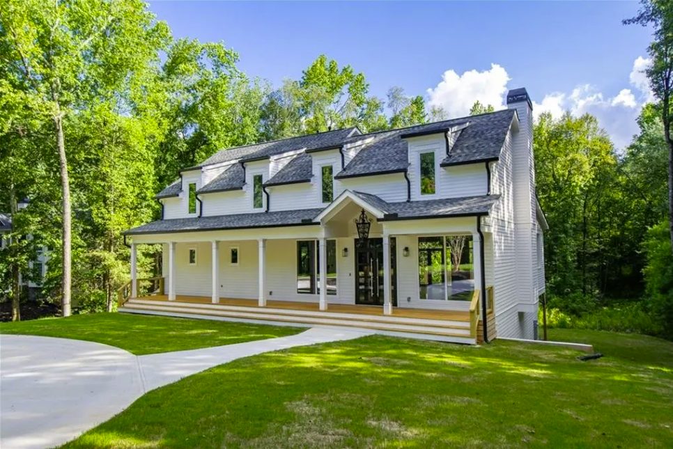 New farmhouse front elevation with dormers and a full-width porch
