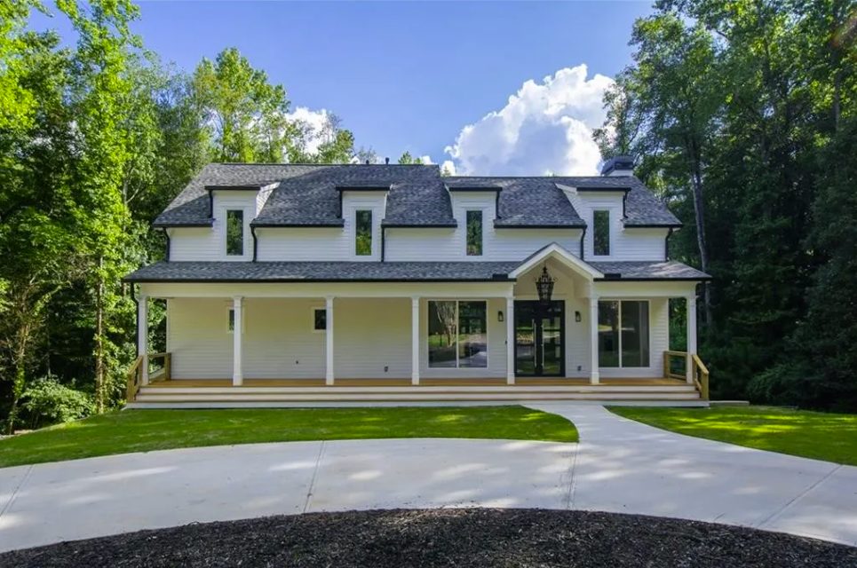 New farmhouse front elevation with dormers and a full-width porch