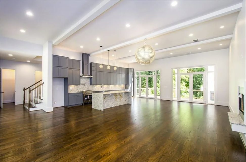 New kitchen with a stone island, gray cabinets and pendant lighting in Sandy Springs
