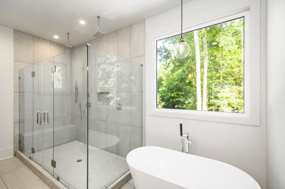 Frameless glass shower beside a freestanding tub in Sandy Springs
