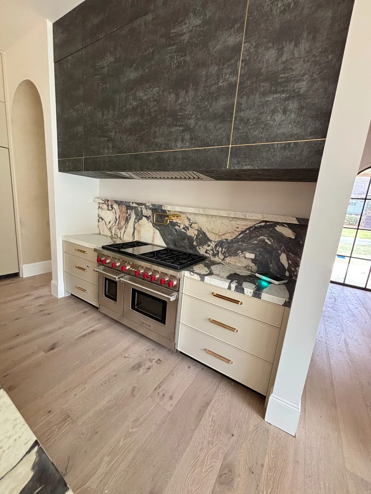 Professional range with a stone slab backsplash going in