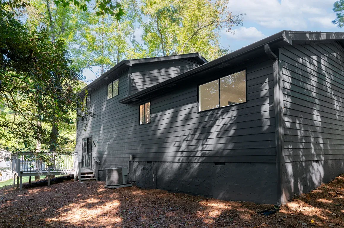 Two-story dark exterior with a projecting upper level