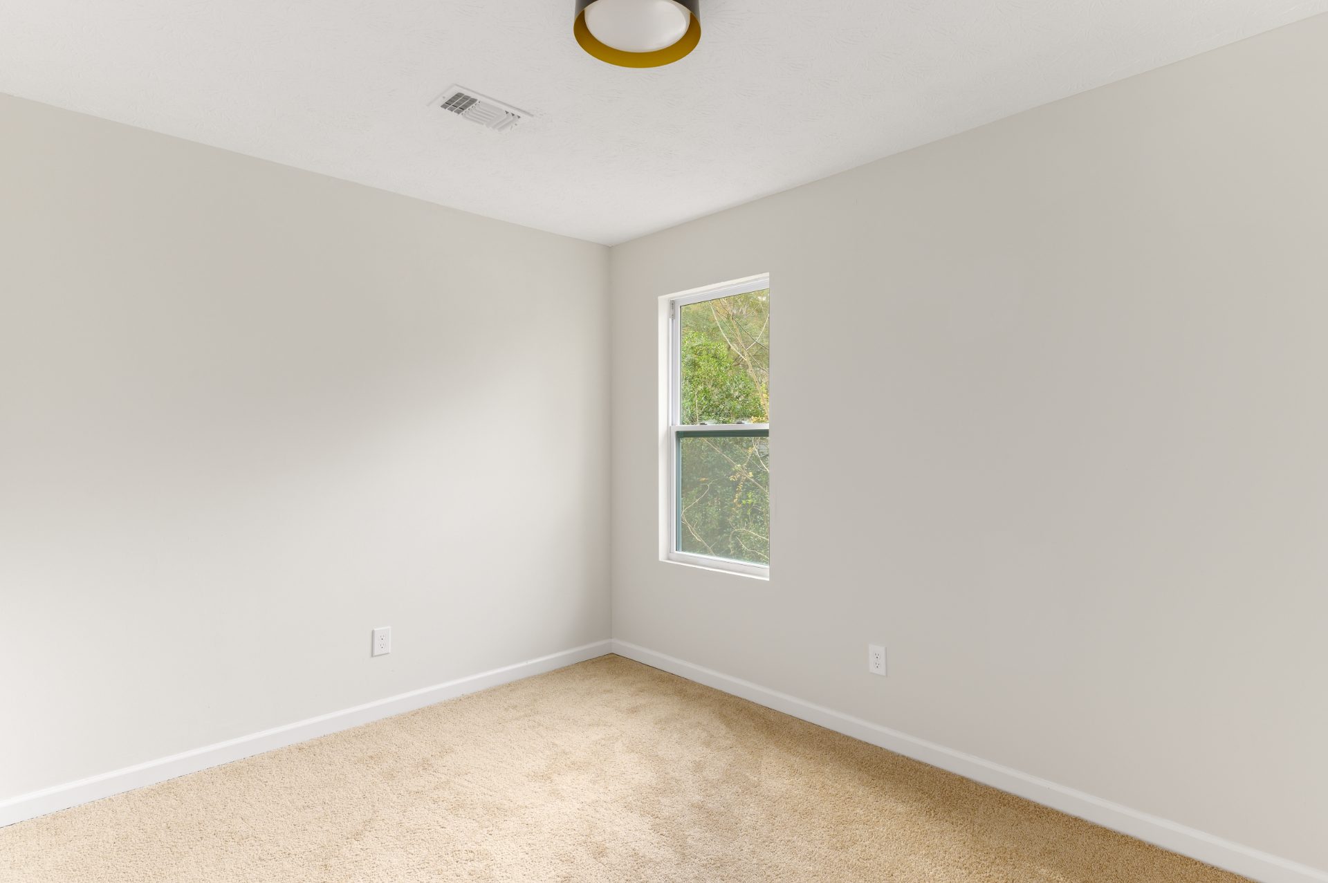 Renovated living space with a stone fireplace and an open staircase in Dunwoody